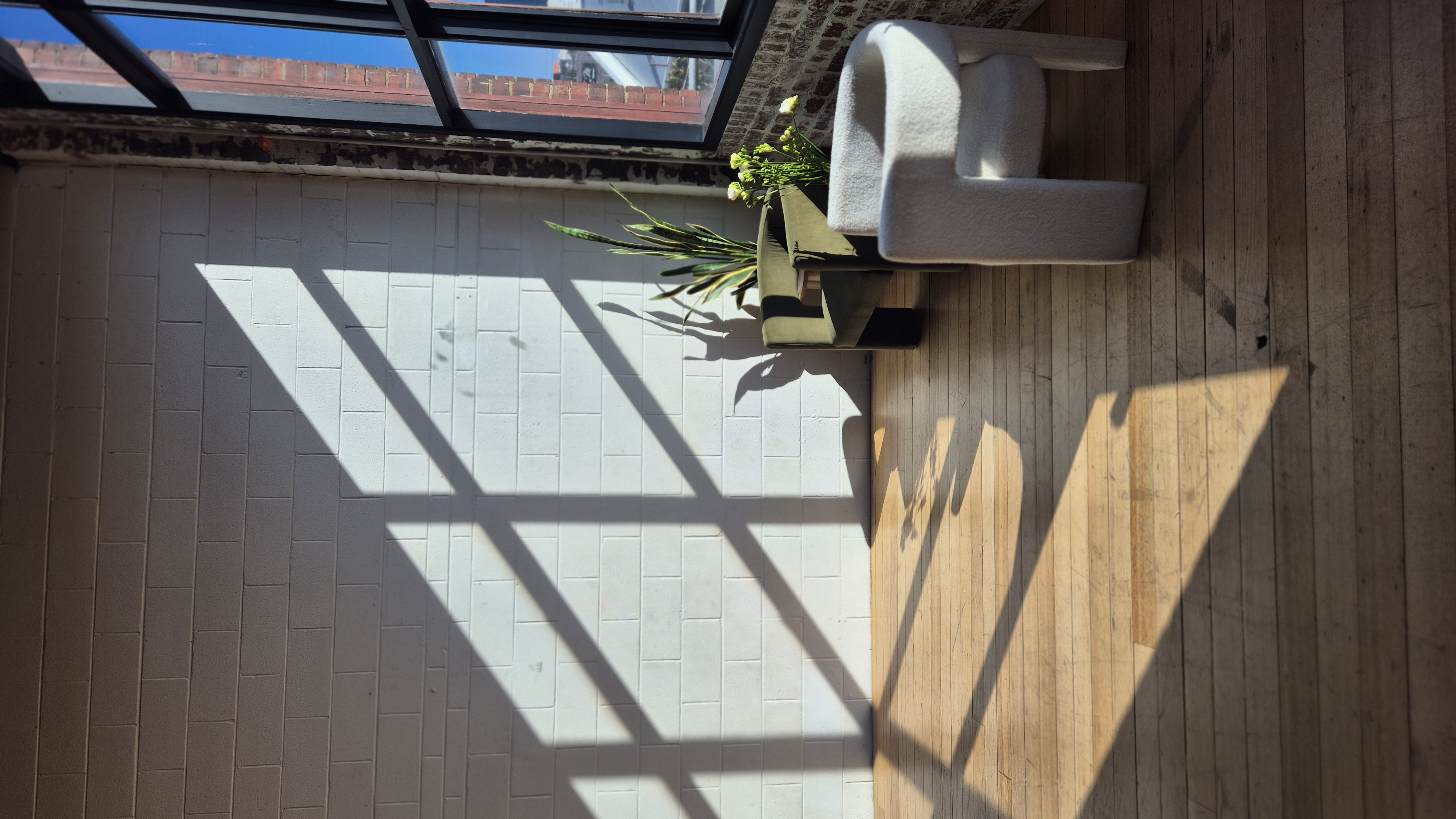 Window light shadows on brick wall